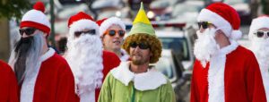 Crowd of men dressed up as Santa Claus and the Elf