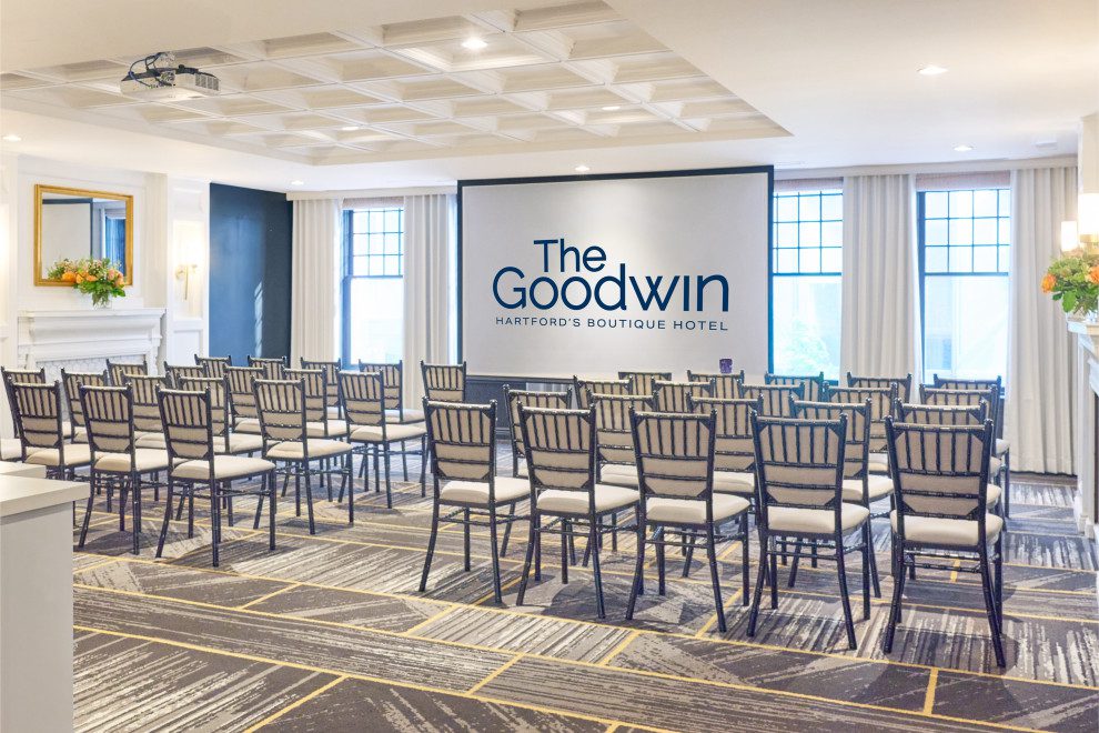 Event room with chairs and screen at the Goodwin